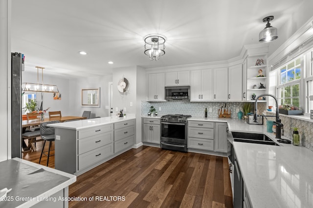 1600 Tuttle Rd, Mason, MI 48854 - kitchen with stainless steel appliances, a chandelier, a sink, backsplash, and recessed lighting