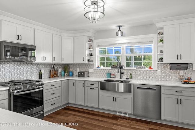 1600 Tuttle Rd, Mason, MI 48854 - kitchen featuring stainless steel appliances, open shelves, a sink, backsplash, and light countertops