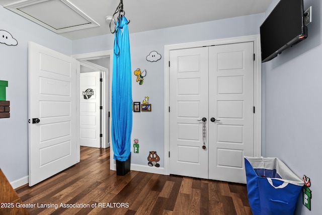1600 Tuttle Rd, Mason, MI 48854 - playroom featuring dark wood-style flooring, baseboards, and attic access