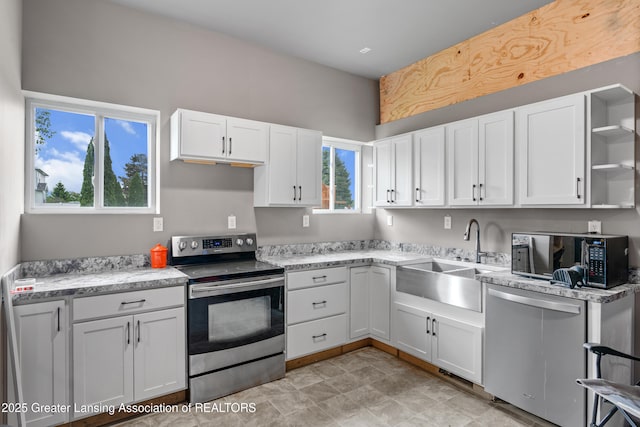 1600 Tuttle Rd, Mason, MI 48854 - kitchen with appliances with stainless steel finishes, a sink, white cabinetry, and open shelves