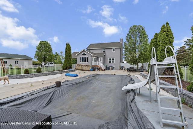 1600 Tuttle Rd, Mason, MI 48854 - back of property featuring a patio area and a chimney