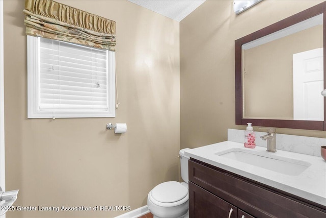 703 Hastay Blvd, Eaton Rapids, MI 48827 - bathroom with toilet, vanity, and baseboards