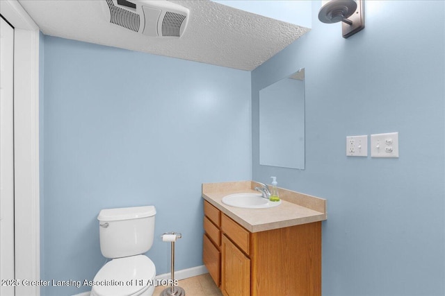 703 Hastay Blvd, Eaton Rapids, MI 48827 - half bath featuring vanity, toilet, and a textured ceiling