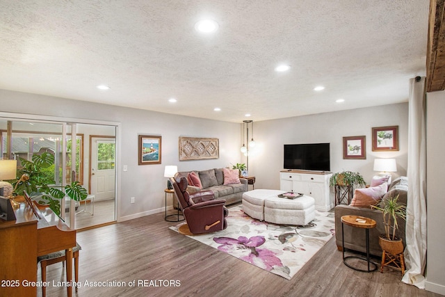 4626 Blackberry Ln, Lansing, MI 48917 - living area with a textured ceiling, recessed lighting, wood finished floors, and baseboards