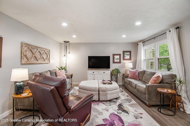 4626 Blackberry Ln, Lansing, MI 48917 - living room with wood finished floors, baseboards, and recessed lighting