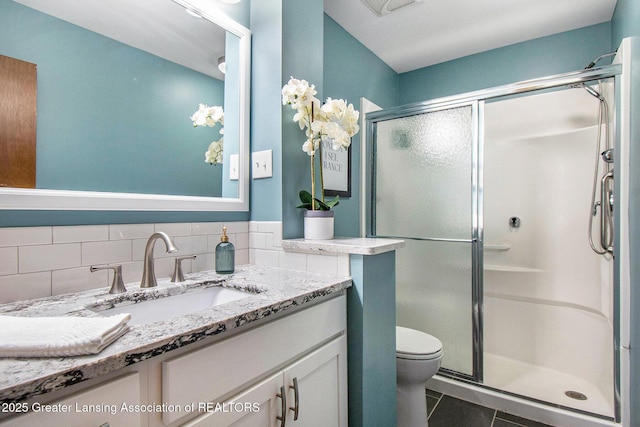 4626 Blackberry Ln, Lansing, MI 48917 - bathroom featuring a stall shower, vanity, toilet, and tile patterned floors