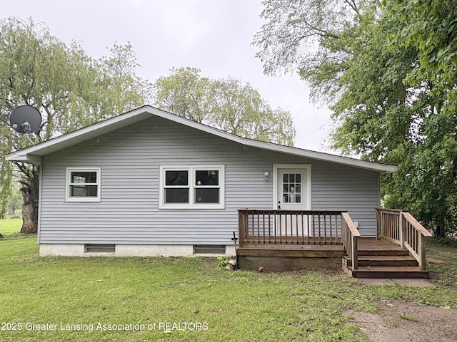 4684 Sherman Rd, Charlotte, MI 48813 - rear view of property with a deck and a yard