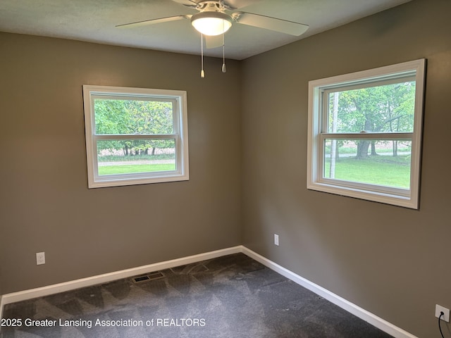 4684 Sherman Rd, Charlotte, MI 48813 - spare room with plenty of natural light, ceiling fan, baseboards, and dark carpet