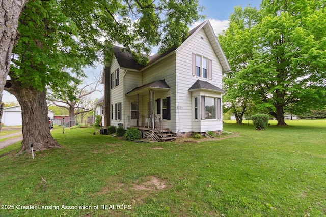 6275 E Clark Rd, Bath, MI 48808 - view of front facade with a front yard and a shingled roof