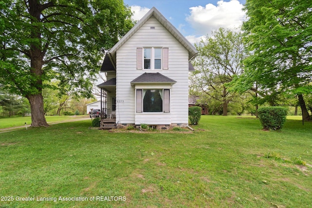 6275 E Clark Rd, Bath, MI 48808 - rear view of property featuring a yard