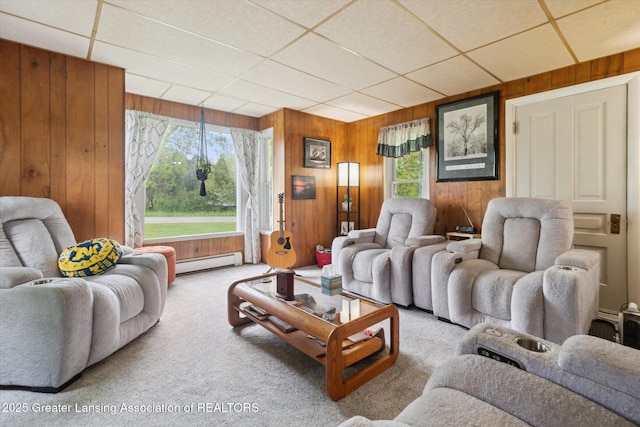 6275 E Clark Rd, Bath, MI 48808 - living area featuring a baseboard radiator, a drop ceiling, wood walls, and carpet floors