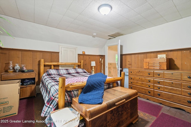 6275 E Clark Rd, Bath, MI 48808 - bedroom featuring wooden walls and a wainscoted wall