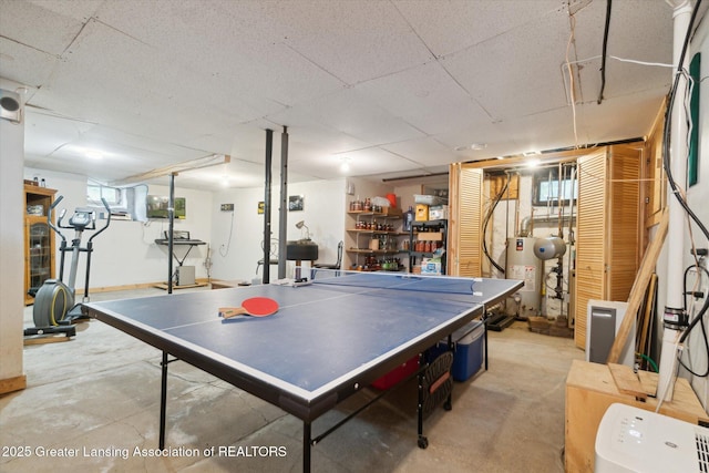 6275 E Clark Rd, Bath, MI 48808 - recreation room featuring unfinished concrete floors and gas water heater