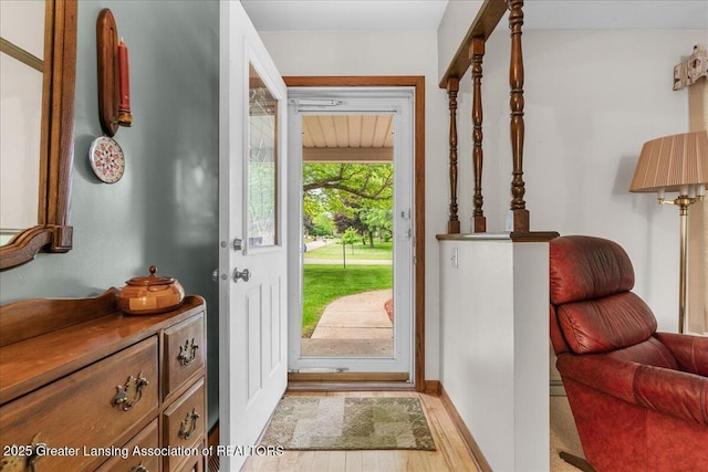 14921 Karl Dr, Lansing, MI 48906 - doorway to outside featuring wood finished floors and baseboards