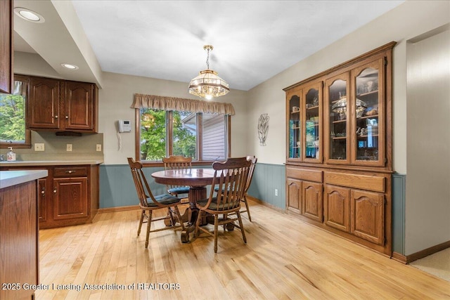 14921 Karl Dr, Lansing, MI 48906 - dining space with light wood-type flooring, a chandelier, wainscoting, recessed lighting, and baseboards