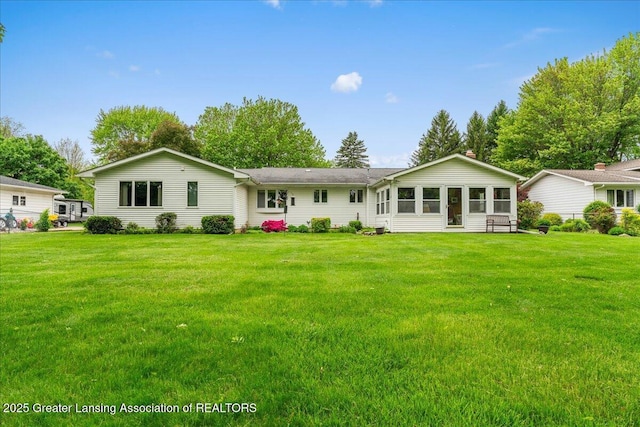 14921 Karl Dr, Lansing, MI 48906 - view of front facade with a front yard and a sunroom