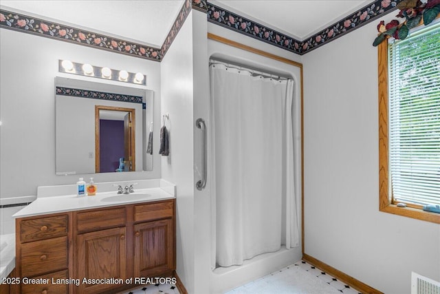 14921 Karl Dr, Lansing, MI 48906 - full bathroom with vanity, a tub to relax in, a shower with curtain, and baseboards