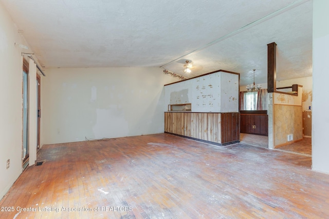 4316 Dumfries Cir, Lansing, MI 48911 - unfurnished living room featuring wood-type flooring and lofted ceiling