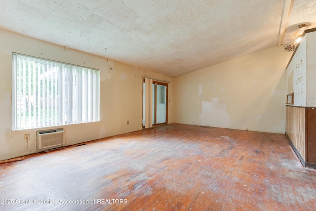 4316 Dumfries Cir, Lansing, MI 48911 - unfurnished room featuring a wall mounted AC, wood finished floors, and vaulted ceiling