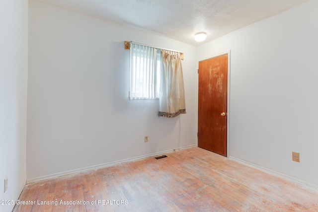 4316 Dumfries Cir, Lansing, MI 48911 - unfurnished room featuring wood-type flooring and baseboards