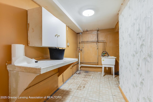 4316 Dumfries Cir, Lansing, MI 48911 - washroom featuring a sink, wallpapered walls, and light flooring