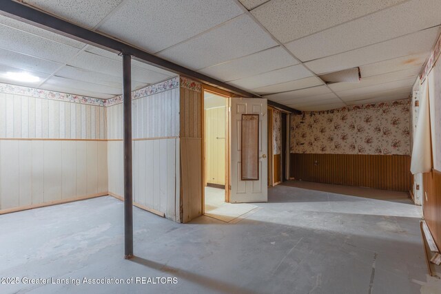 4316 Dumfries Cir, Lansing, MI 48911 - basement featuring wallpapered walls, a paneled ceiling, and a wainscoted wall
