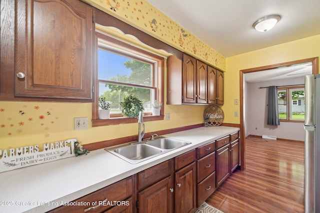 445 S Oak St, Maple Rapids, MI 48853 - kitchen with a sink, light countertops, wood finished floors, and freestanding refrigerator