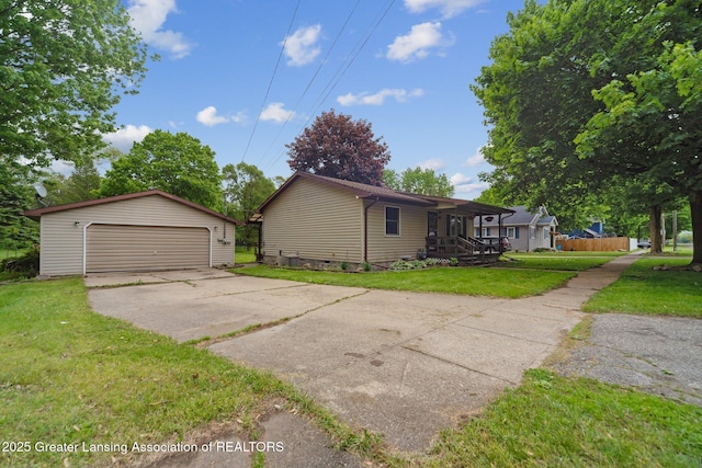 445 S Oak St, Maple Rapids, MI 48853 - view of side of home with an outdoor structure, a yard, a detached garage, and a porch