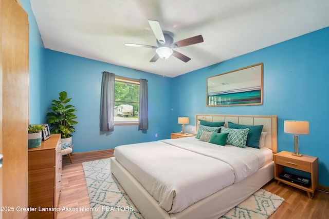 445 S Oak St, Maple Rapids, MI 48853 - bedroom with wood finished floors, baseboards, and a ceiling fan