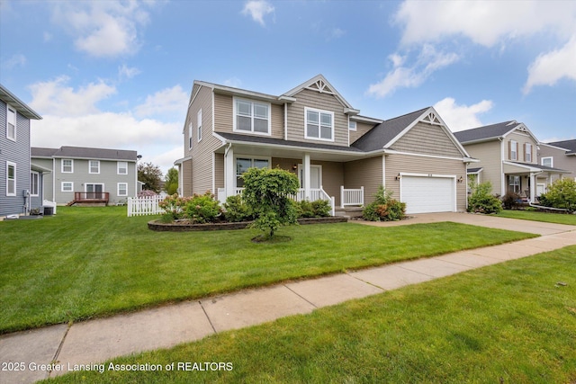 619 Willet Way E, Lansing, MI 48823 - view of front of house with covered porch, driveway, and an attached garage