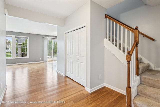 619 Willet Way E, Lansing, MI 48823 - stairs featuring wood finished floors and baseboards