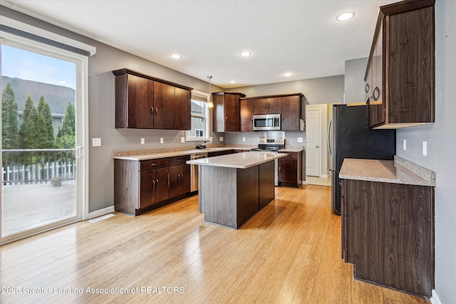 619 Willet Way E, Lansing, MI 48823 - kitchen featuring appliances with stainless steel finishes, dark brown cabinetry, a center island, light wood-style flooring, and recessed lighting