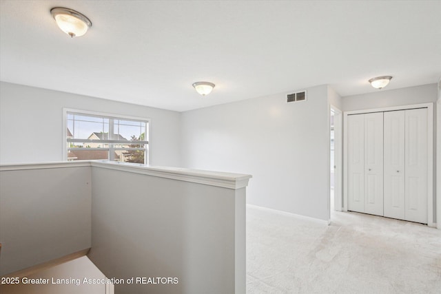 619 Willet Way E, Lansing, MI 48823 - hallway featuring an upstairs landing, light colored carpet, and baseboards