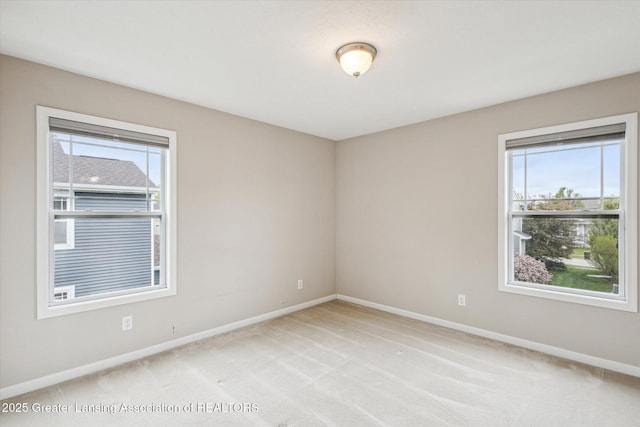 619 Willet Way E, Lansing, MI 48823 - spare room featuring healthy amount of natural light, baseboards, and light carpet