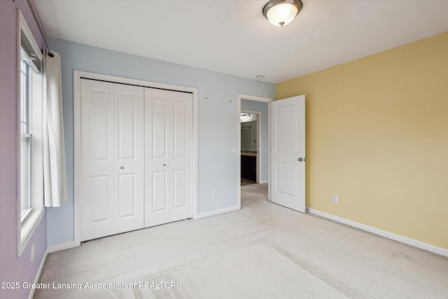 619 Willet Way E, Lansing, MI 48823 - unfurnished bedroom featuring baseboards, carpet flooring, and a closet