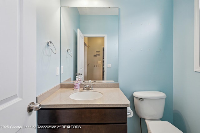 619 Willet Way E, Lansing, MI 48823 - half bathroom featuring toilet and vanity