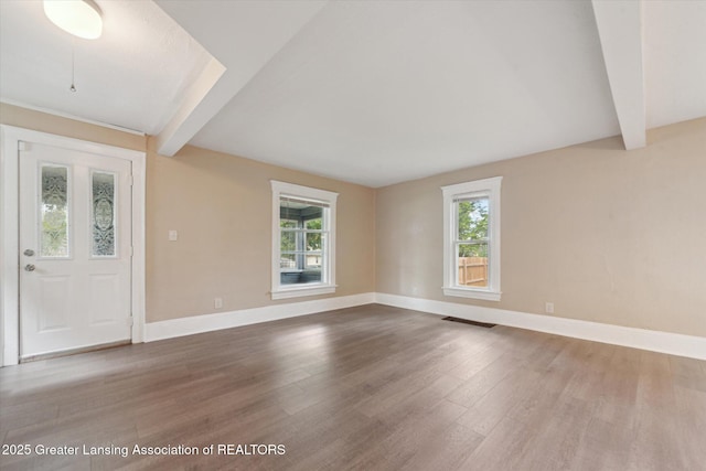 139 W Mansion St, Jackson, MI 49203 - spare room featuring beamed ceiling, wood finished floors, and baseboards