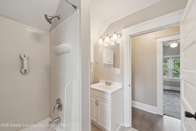 139 W Mansion St, Jackson, MI 49203 - bathroom with vanity, shower / bathtub combination, wood finished floors, and baseboards