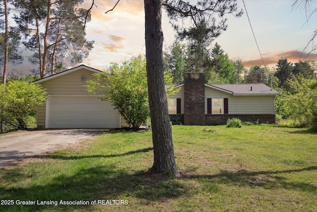 7050 E Eaton Hwy, Sunfield, MI 48890 - view of front of home featuring a lawn, a chimney, a detached garage, and brick siding