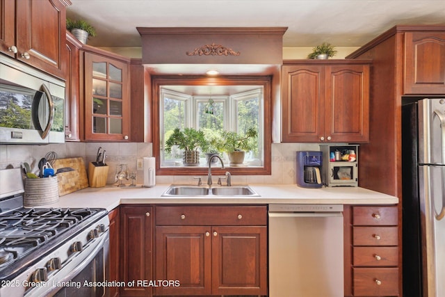 7050 E Eaton Hwy, Sunfield, MI 48890 - kitchen with appliances with stainless steel finishes, a sink, tasteful backsplash, and light countertops