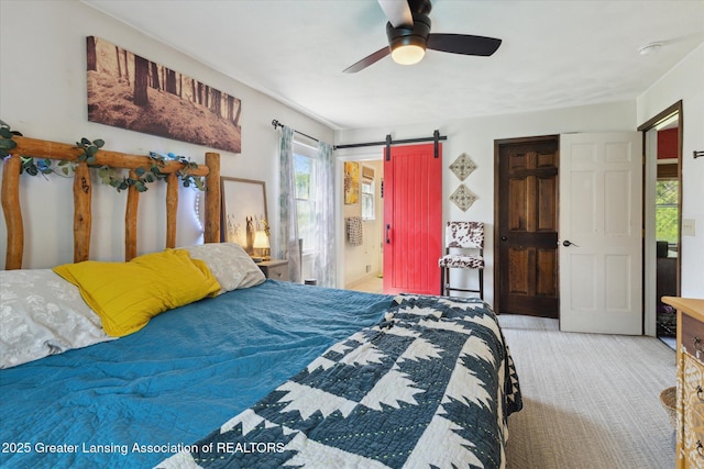 7050 E Eaton Hwy, Sunfield, MI 48890 - bedroom with carpet floors, multiple windows, a ceiling fan, and a barn door