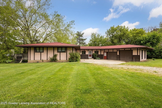 7161 E Eaton Hwy, Mulliken, MI 48861 - view of front of house featuring driveway, a front lawn, and an attached garage