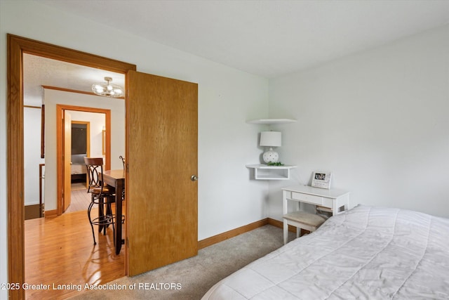 7161 E Eaton Hwy, Mulliken, MI 48861 - bedroom featuring baseboards and a chandelier