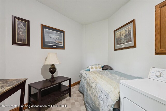 7161 E Eaton Hwy, Mulliken, MI 48861 - bedroom featuring washer / dryer, baseboards, and light floors