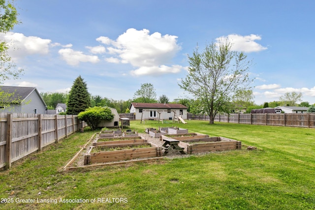 114 Walker Dr, Morrice, MI 48857 - view of yard featuring a garden and an outbuilding