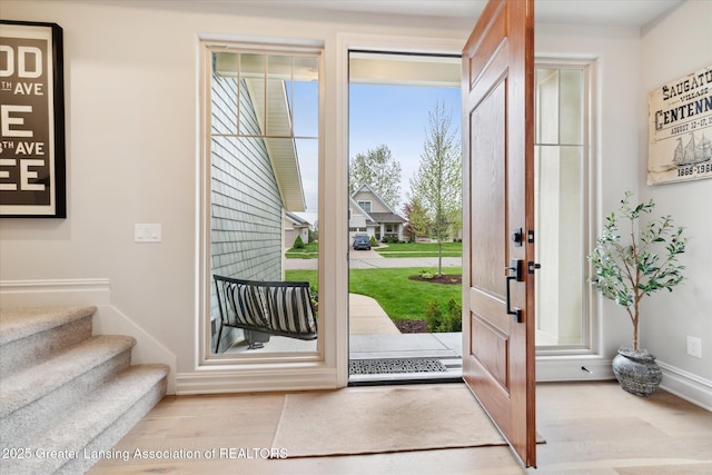 16851 Meadowbrook Dr, Haslett, MI 48840 - foyer entrance featuring wood finished floors, baseboards, and stairway