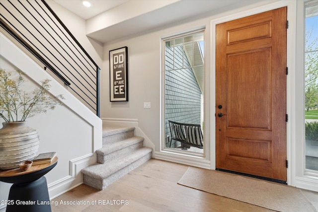 16851 Meadowbrook Dr, Haslett, MI 48840 - foyer featuring stairs, light wood finished floors, and recessed lighting