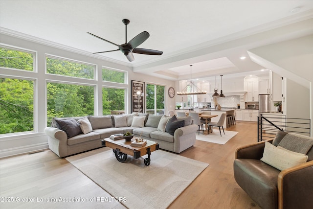 16851 Meadowbrook Dr, Haslett, MI 48840 - living area with ornamental molding, a ceiling fan, light wood-style flooring, a chandelier, and recessed lighting