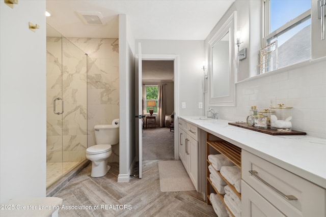 16851 Meadowbrook Dr, Haslett, MI 48840 - full bathroom featuring toilet, a marble finish shower, and vanity