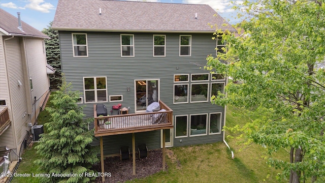16851 Meadowbrook Dr, Haslett, MI 48840 - rear view of house with a deck, cooling unit, a lawn, and a shingled roof